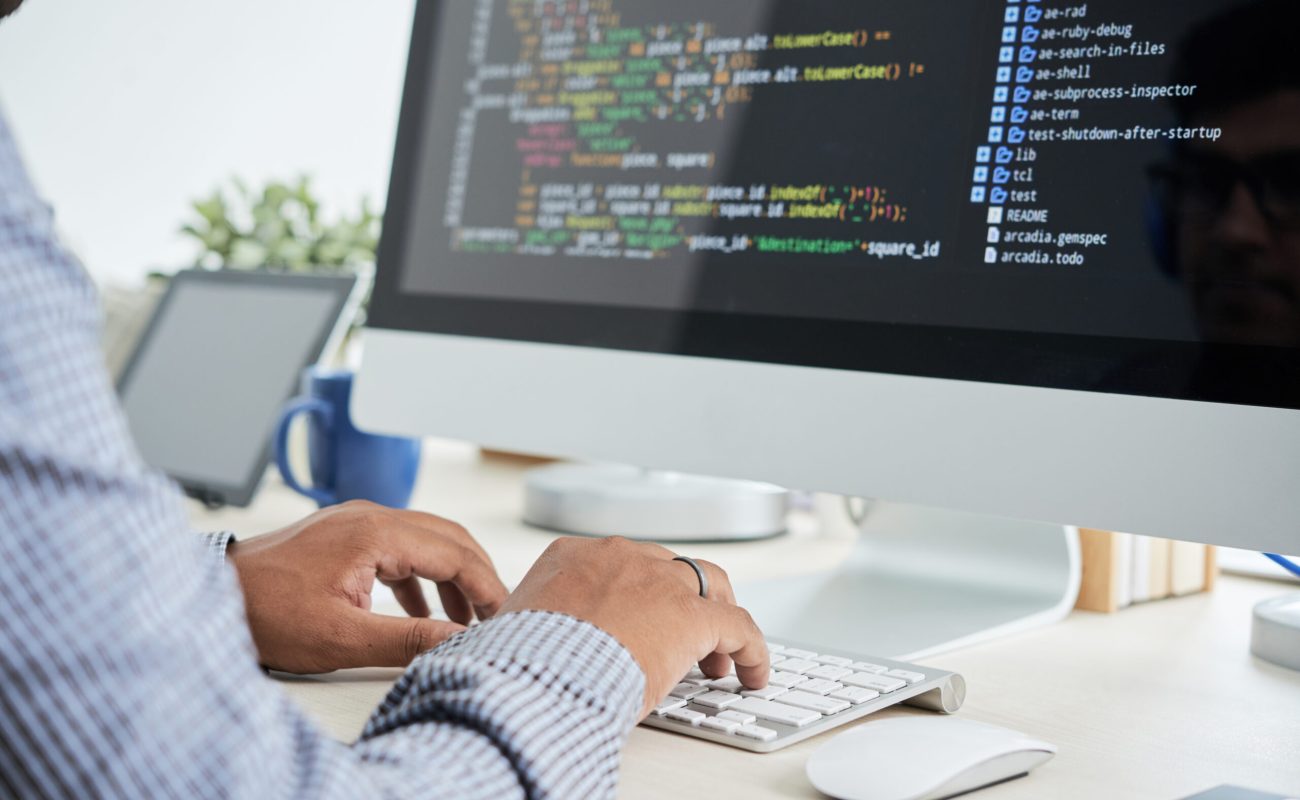 Cropped image of It specialist working on code