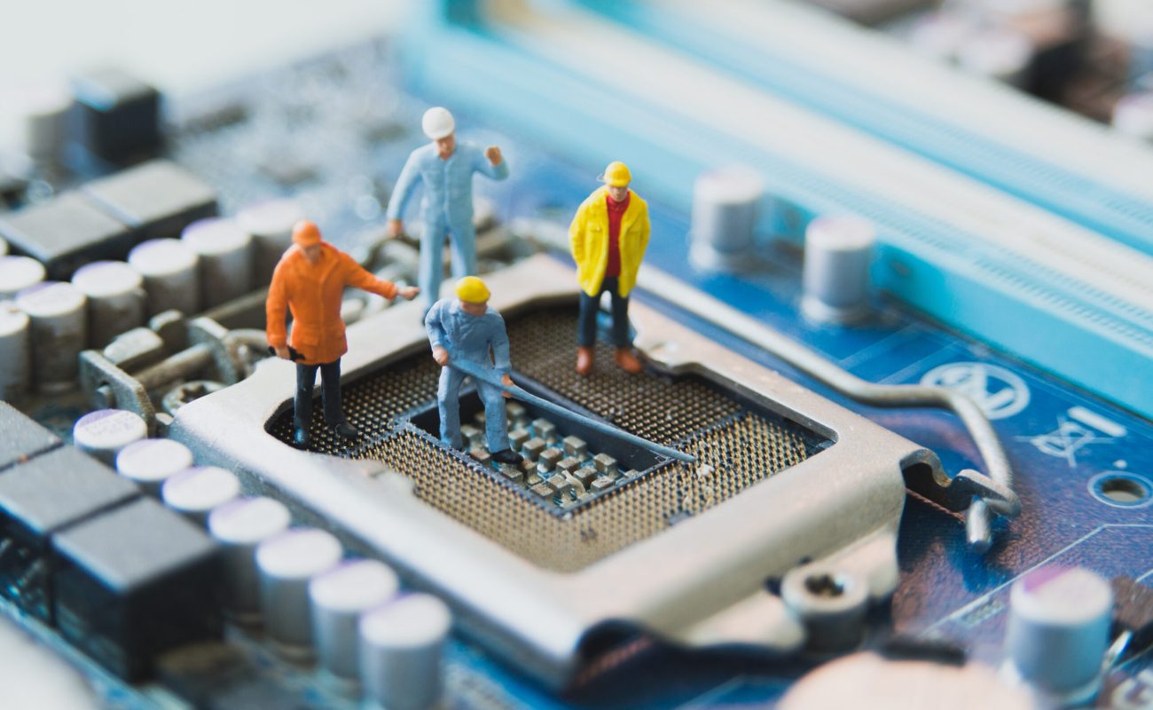 Miniature people Network Engineers At mainborad computer